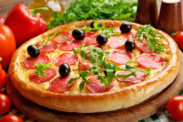 Tasty pizza with salami on decorated wooden table, close up