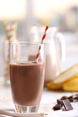 Glass of chocolate milk on table close-up