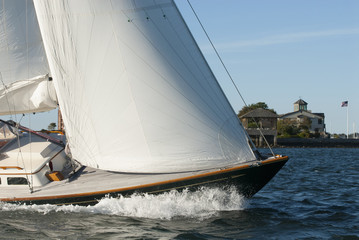 Adventure sailing as sailboat cuts through the water in Newport Harbor, Rhode Island. Newport is known as the yachting capital of the world.