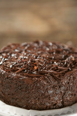 Tasty chocolate cake on wooden background