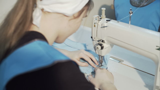 Woman seamstress work on the sewing-machine