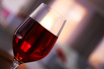 Glass of red wine on blurred background