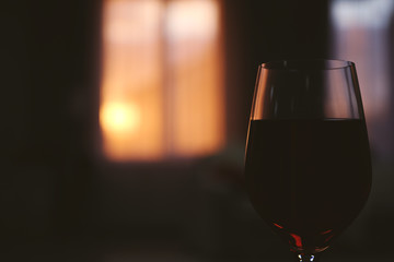 Glass of red wine on blurred background