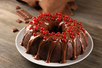 Chocolate cake with snowball tree berries on a table