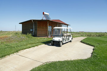Fototapeta na wymiar White golf carts at the green golf course