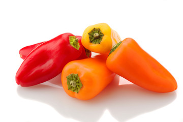 group of colored peppers on white base
