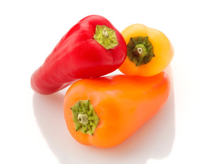 group of colored peppers on white base