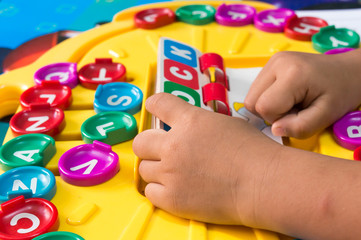 Asian children's Hand  to play alphabet games, Selective focus to Hand  