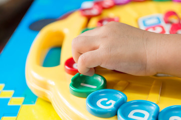Asian children's Hand  to play alphabet games, Selective focus to Hand

