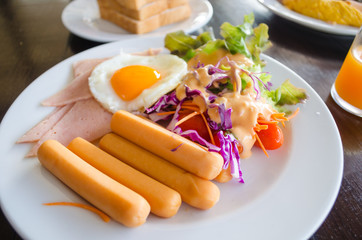 breakfast with hotdog fried egg and salad