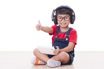 Happy boy with headphones on the head listening to the music with looking up.