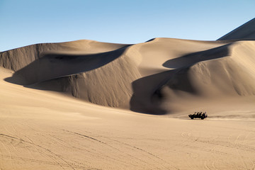 Fototapeta na wymiar Dune buggy rides the sand dunes in Huacachina desert, Peru
