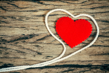 Valentines Day background with red hearts on wooden board.