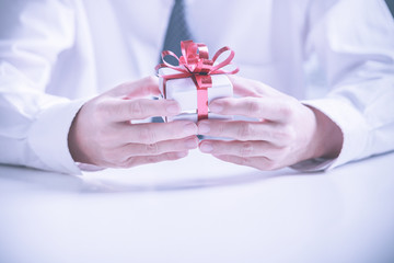 Business man offering a gift