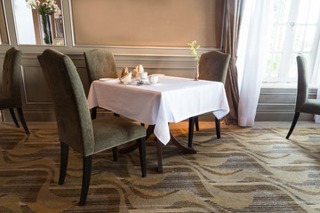 Elegant dining table with cutleries set arranged for two person