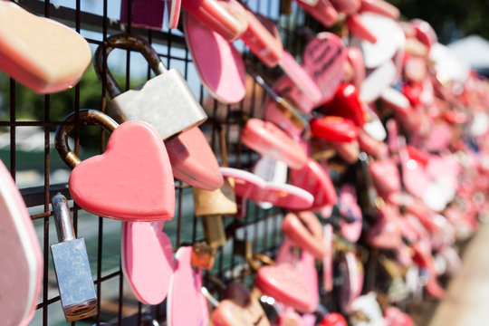 Closeup on pink love locks hanging with space for copy