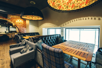 Loft coffee room interior design, wooden floor, big windows, luxury sofa