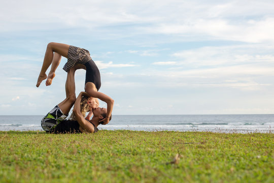 Love beautiful couple on the beach doing dancing fitness yoga exercise together. Valentine day love beautiful