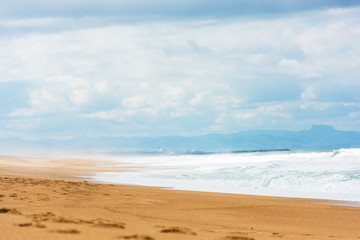 Fototapeta na wymiar Long Sand Atlantic Beach with ocean waves