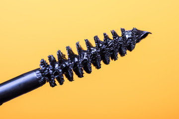 Mascara stick isolated on gold background