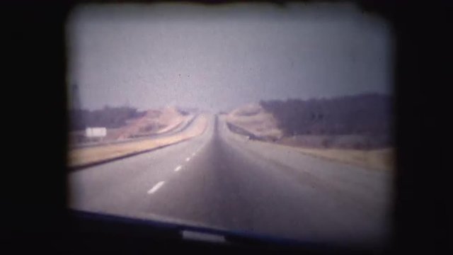 Vintage 8mm footage film through the window of a car or truck