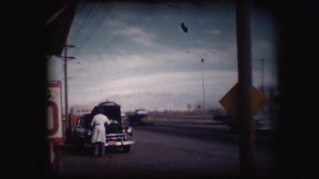 Vintage 8mm footage of a car at a gas or service station