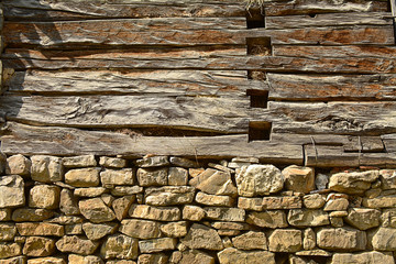 Old wooden wall with stone base