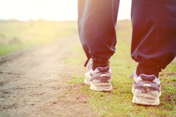 close up of feet of runner running in autumn