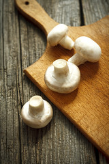 Champignon on wooden background