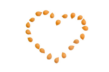 Shelled apricot kernels, put in the shape of heart