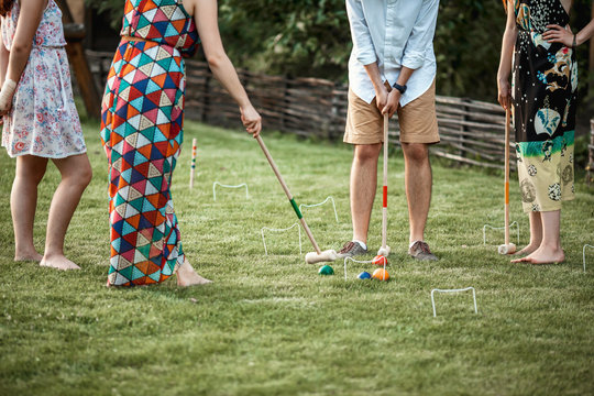 men and women playing Golf on green grass