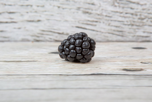 Blackberry fruit over wooden background