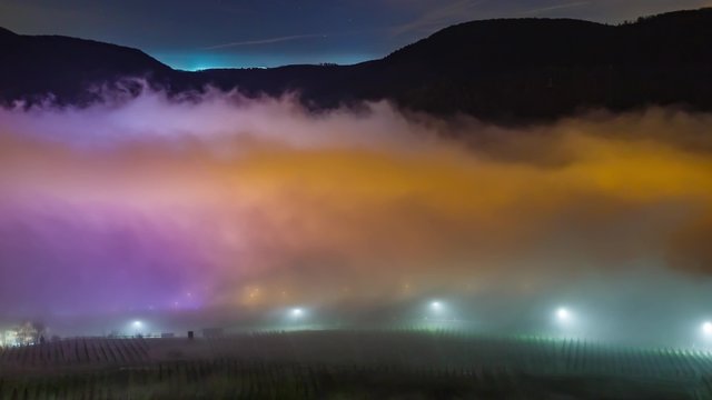 Foggy Winternight over a Town Timelapse UHD - Zoom In