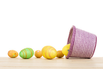 Fototapeta na wymiar Easter eggs and decorative pink basket isolated.