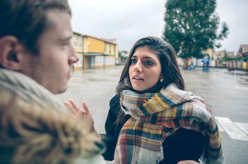 Angry woman having argument to man in quarrel