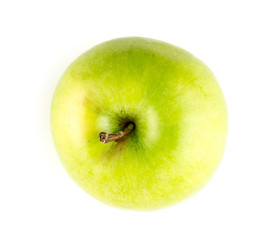 Aerial view of round yellowish green apple with stem