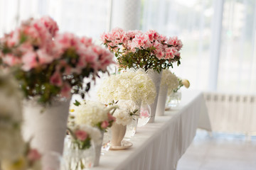 a lot of flowers on a table in a cafe