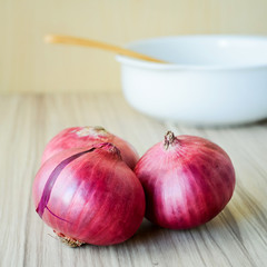 Red Onion on old wooden background