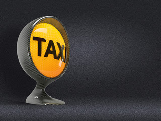 illuminated taxi sign on a carbon headlight on asphalt background