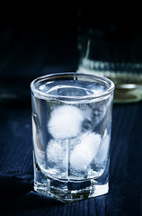 Cold vodka in a sweaty glass, toned image, selective focus