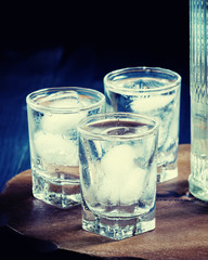 Cold vodka in a sweaty glass, toned image, selective focus