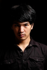 Fototapeta premium Asian man portrait in the dark