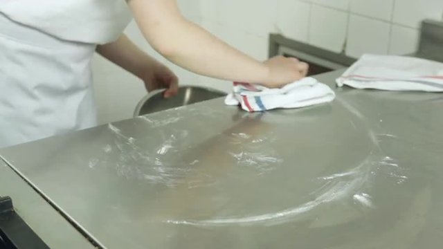 Woman cleaning the kitchen desk