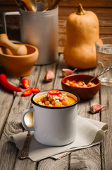Pumpkin soup with bacon, chickpea and feta. Rustic background. Style rustic. Selective focus.