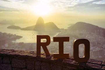 Poster Golden RIO sign standing morning sunrise overlook view of Rio de Janeiro city skyline and Sugarloaf Mountain © lazyllama