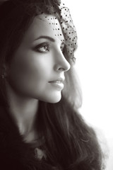 Fototapeta premium Retro portrasit of Elegant brunette woman in hat with veil look