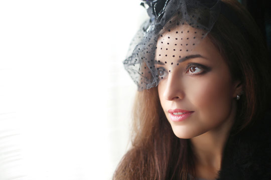 Retro portrait of Elegant brunette woman wearing in hat with vei