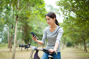Fototapeta na wymiar Woman checking the routine when go for cycling