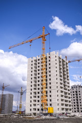 Fototapeta premium New multistorey housing and tall cranes
