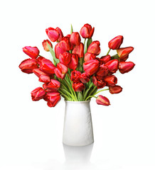 Bouquet of red tulips in white vase